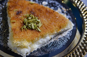 kunafa served in a dish isolated on dark background side view of arabic sweet