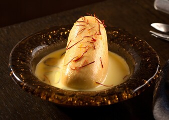 Ras Malai served in a dish isolated on dark background side view of pakistani sweet