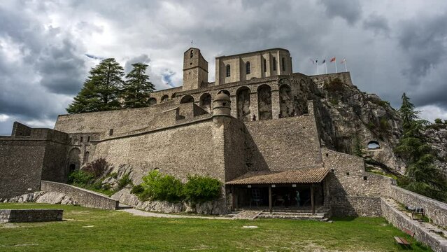 Time lapse footage of the Citadelle de Sisteron in France inder a gloomy sky