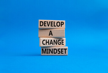 Develop a change mindset symbol. Concept words Develop a change mindset on wooden blocks. Beautiful blue background. Business and Develop a change mindset concept. Copy space.
