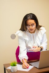 Vertical view of a female writing on the paper while standing