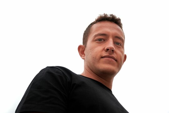 Low angle portrait of a hispanic man isolated on a whit background