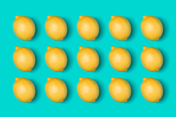 Creative layout made of lemon pattern. Flat lay, top view. Food concept. Fruits isolated on blue background.