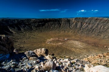 Meteor Crater ( Barringer Crater) with rocks under a blue sky