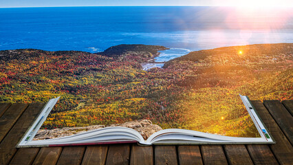 Open book on wooden deck with autumn view in Acadia National Park in Maine