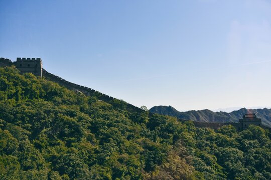 Beautiful shot of the Great Wall of China with trees and blue skyline