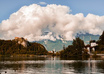 Bled lake with the island trees and a cloudscape