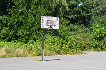 Old basketball hoop on a sunny summer day.