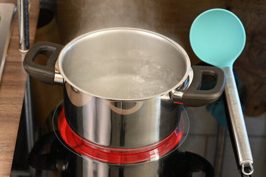 Boiling water in a pan on a hot stove.