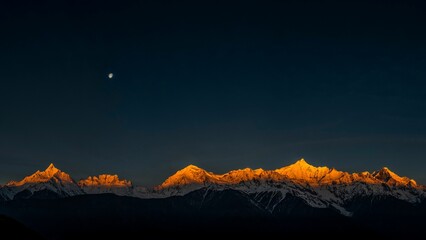 Beautiful landscape of mountains covered in snow on the sunrise