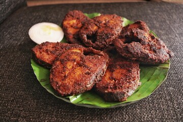 Closeup of fried tasty seafood on plate in Kerala tyle