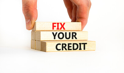 Fix your credit symbol. Concept words Fix your credit on wooden blocks on a beautiful white table white background. Businessman hand. Business, finacial and fix your credit concept. Copy space.