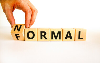 Formal or normal symbol. Businessman turns wooden cubes and changes the concept word formal to normal. Beautiful white table white background. Business formal or normal concept. Copy space.