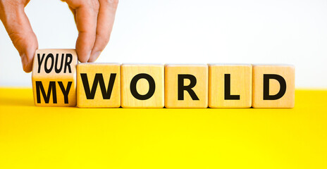 My or your world symbol. Businessman turns wooden cubes and changes concept words Your world to My world. Beautiful yellow table white background. Business and my or your world concept. Copy space.