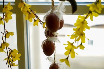 Closeup shot of decorative Easter eggs and yellow flowers