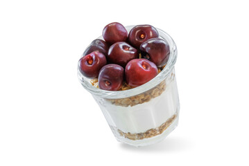 Cherry Greek yogurt granola parfait in a glass on a white isolated background