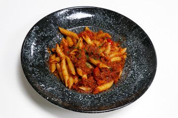 penne pasta with beef bolognese and tomato sauce in a serving bowl
