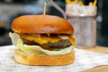 angus beef burger with cheddar cheese, tomatoes,eggs and lettuce in close up