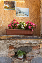 Facade of an ancient building.Beautiful flowers on the windowsill.