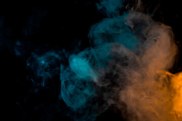 movement of a cloud of cigarette vapour in different colours degrading from orange to blue, on dark background. banner with illuminated coloured smoke.