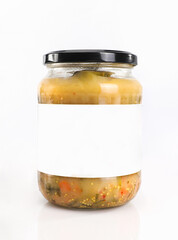 A glass jar with pickled cucumbers, isolated. Jar of pickled veggies with a blank label for packaging design, template.