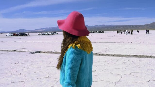 Woman Walking in Salinas Grandes Salt Flats, Jujuy Province, North West of Argentina, South America.