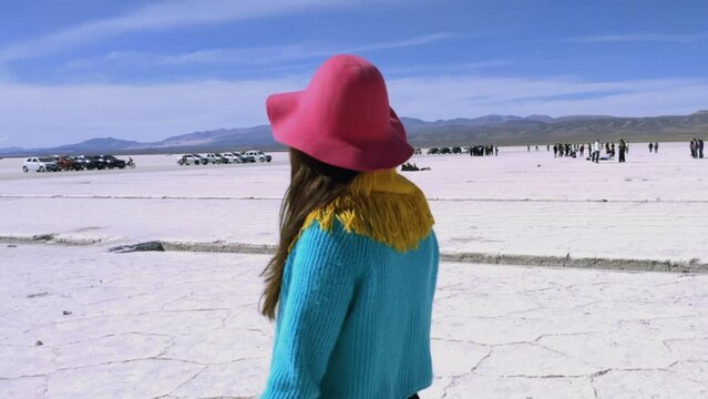 Woman Walking in Salinas Grandes Salt Flats, Jujuy Province, North West of Argentina, South America. Slow Motion.