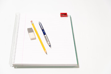 school equipment on blank notebook