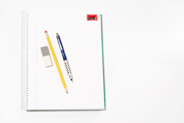 school equipment on blank notebook