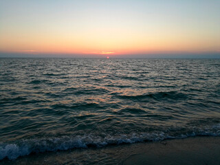 Incredibly beautiful sunset on the beach in Thailand. Sun, sky, sea, waves and sand. A holiday by the sea