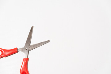 red open paper scissors on white table