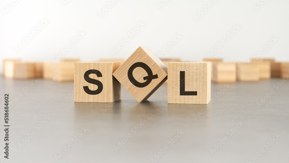Poster wooden cube with the letter from the sql word. wooden cubes standing on gray background. sql - short