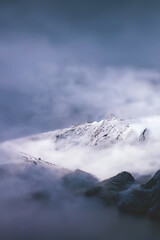 Mountain landscape. Mountain tops in fog. Fantasy landscape, mountain rocks. 3D illustration.