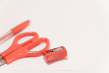 red school equipment on a white table