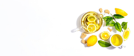Lemon tea with ripe fruits and fresh leaves isolated on white background
