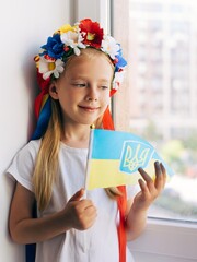 Girl with a flag of Ukraine. Child. Ukrainian child. War. Blue. Yellow. Pray for Ukraine. Ukrainian wreath on the head - 518685897