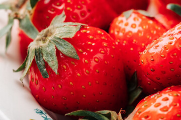 Fresh ripe juicy strawberries in a bowl close-up