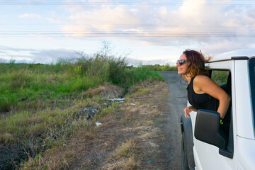 girl leaning out of a car window
