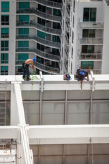 Window washers on top of highrise building, MIami, Florida, USA