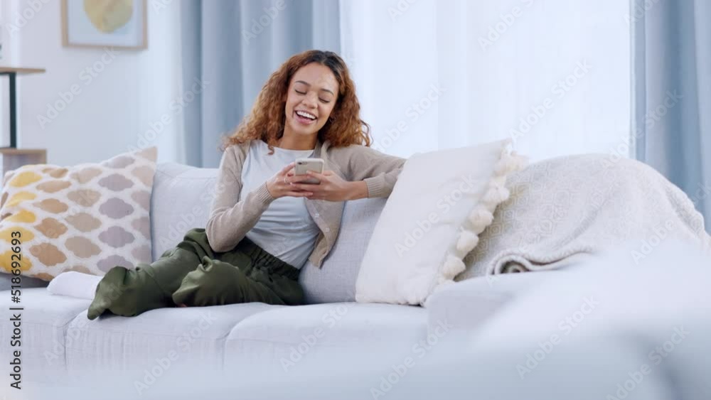 Leinwandbilder a relaxed woman reading and replying to a funny text on a phone. a lady playing an online mobile gam