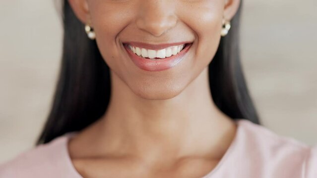 Lady with clean teeth smiling after her dentist appointment. Close up portrait of beautiful womans mouth with white teeth, cheerful after teeth whitening dental treatment. Woman with pretty lips