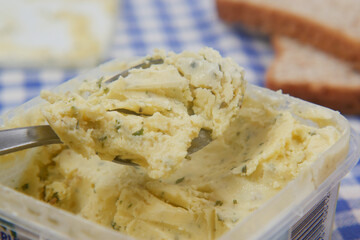fresh garlic butter in a container on white background 
