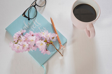 notebooks for notes and delicate spring flowers. lovely soft colors. Selective focus.
