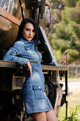 Young Woman Posing While Resting Her Elbows On An Old Train