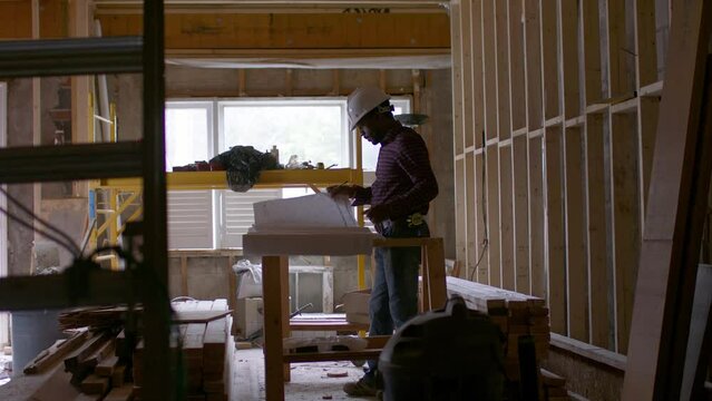 A contractor works on the plans for his clients dream home. 