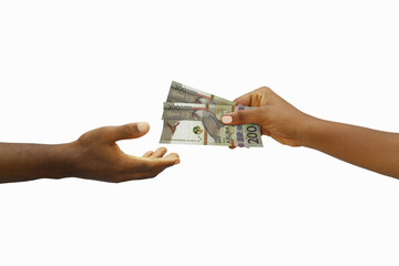 Hand giving 200 Aruban florin notes to another hand. Hand receiving money