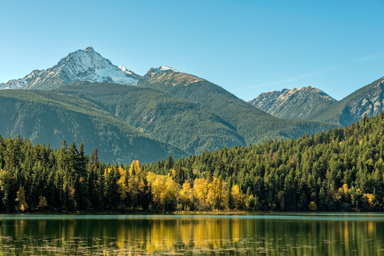 Mountains Tower Above The Autumn Foliage At Gun Lake In British Columbia, Canada