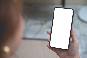 Close up women using a smartphone with an empty white screen at home.