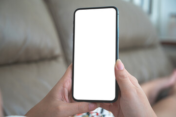 Close up relax women using a smartphone with an empty white screen lazy on the sofa at home.