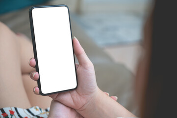 Close up relax women using a smartphone with an empty white screen lazy on the sofa at home.